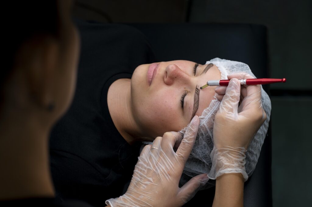 Beautician performing a non-surgical eyebrow tightening procedure on a woman at Kliaro Derma clinic in Bangalore.